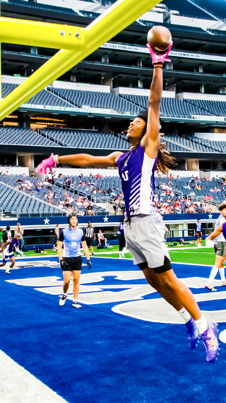 Player dunking football over goalpost